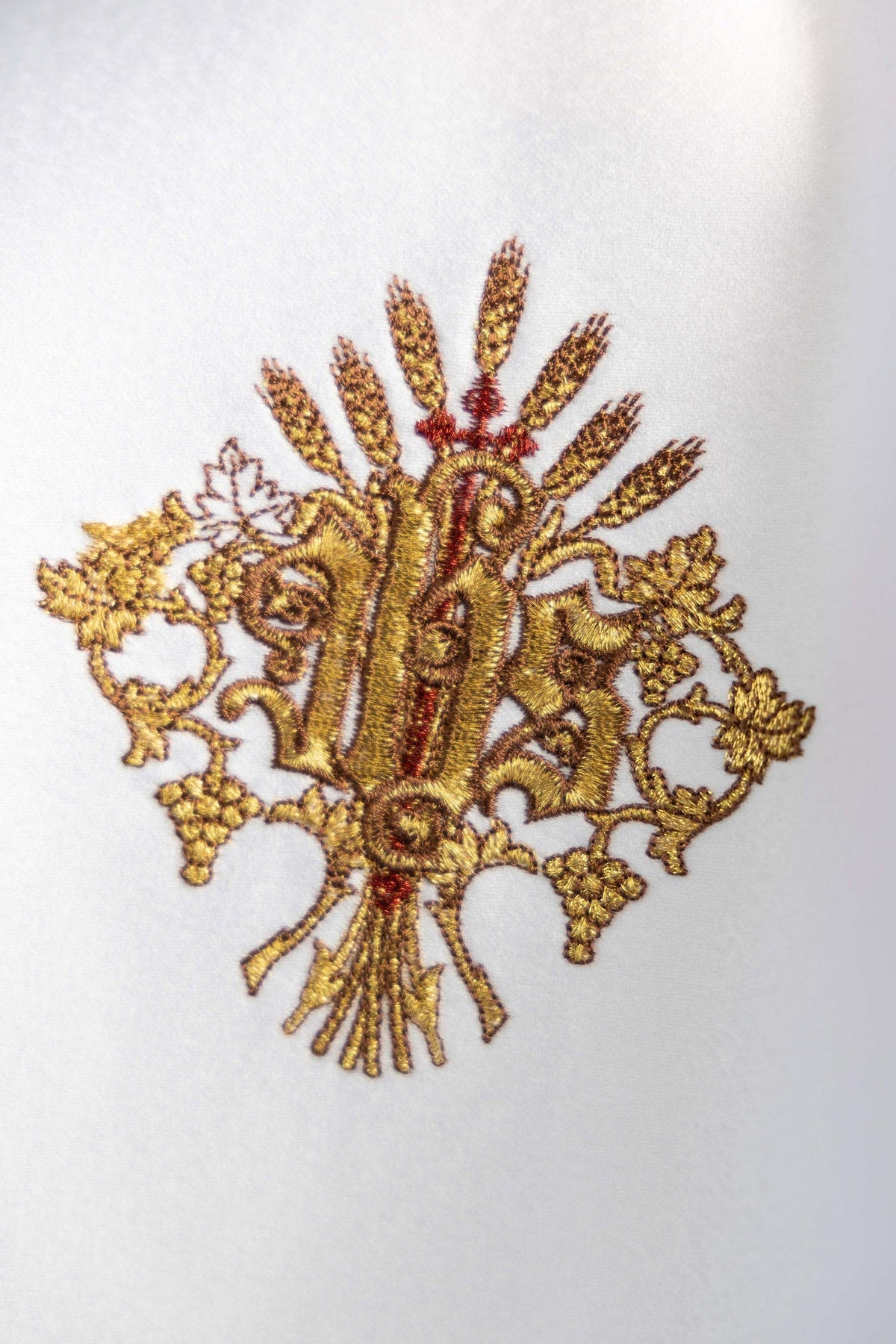 Cubrecopón blanco, detalle del bordado dorado de IHS